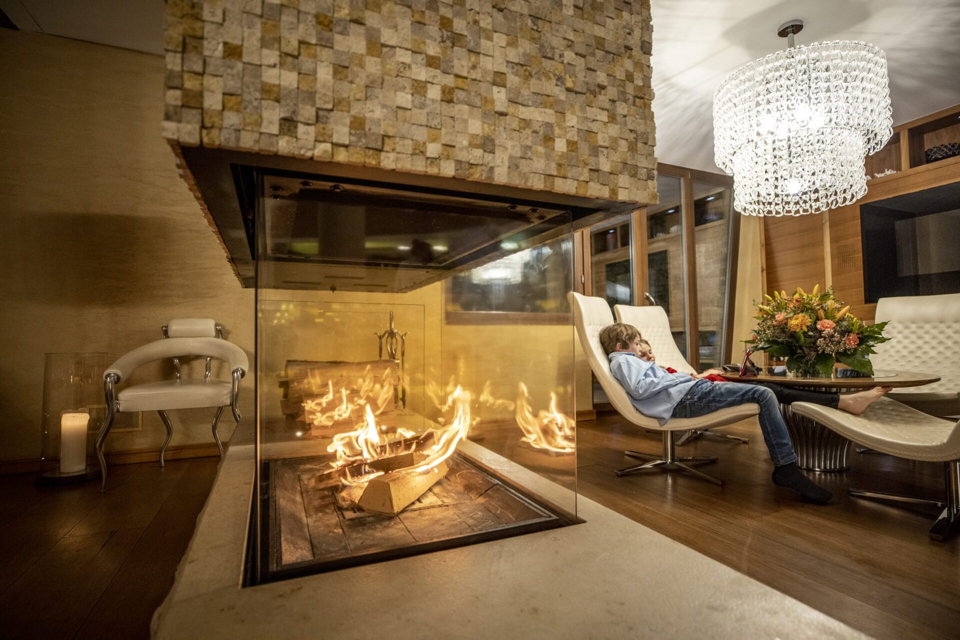 Kids by fireplace watching ipad